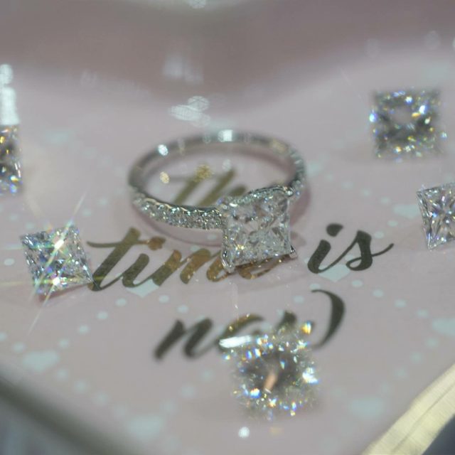 Princess-cut engagement ring surrounded by loose princess-cut diamonds