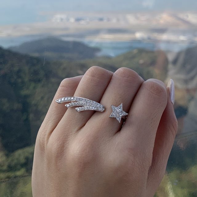 Shooting star ring with a star of five natural diamonds, worn on a hand